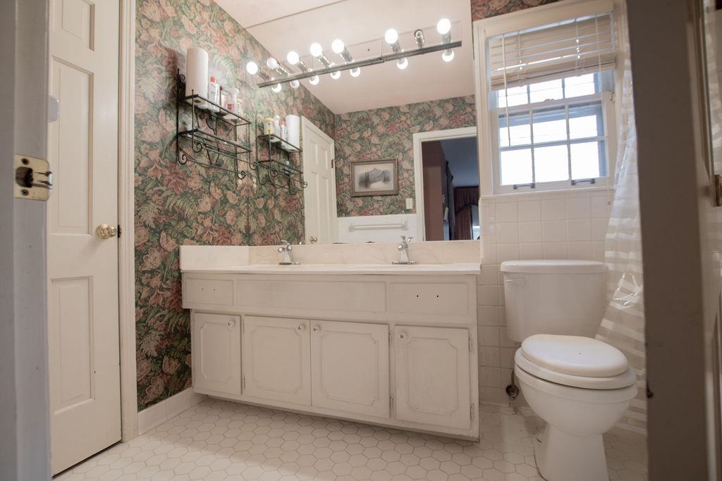 320 South Yates Road Memphis, TN 38120 - Photo 11 of 14 a bathroom with a sink a toilet a mirror and shower