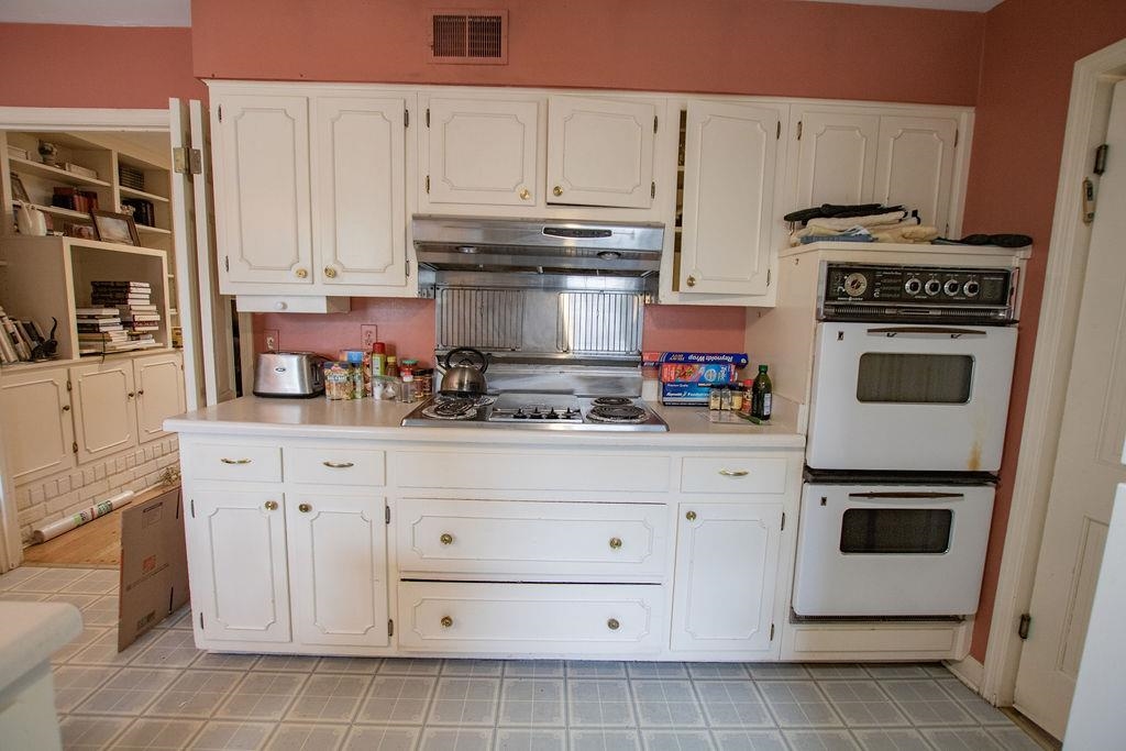 320 South Yates Road Memphis, TN 38120 - Photo 6 of 14 a kitchen with granite countertop white cabinets and white appliances