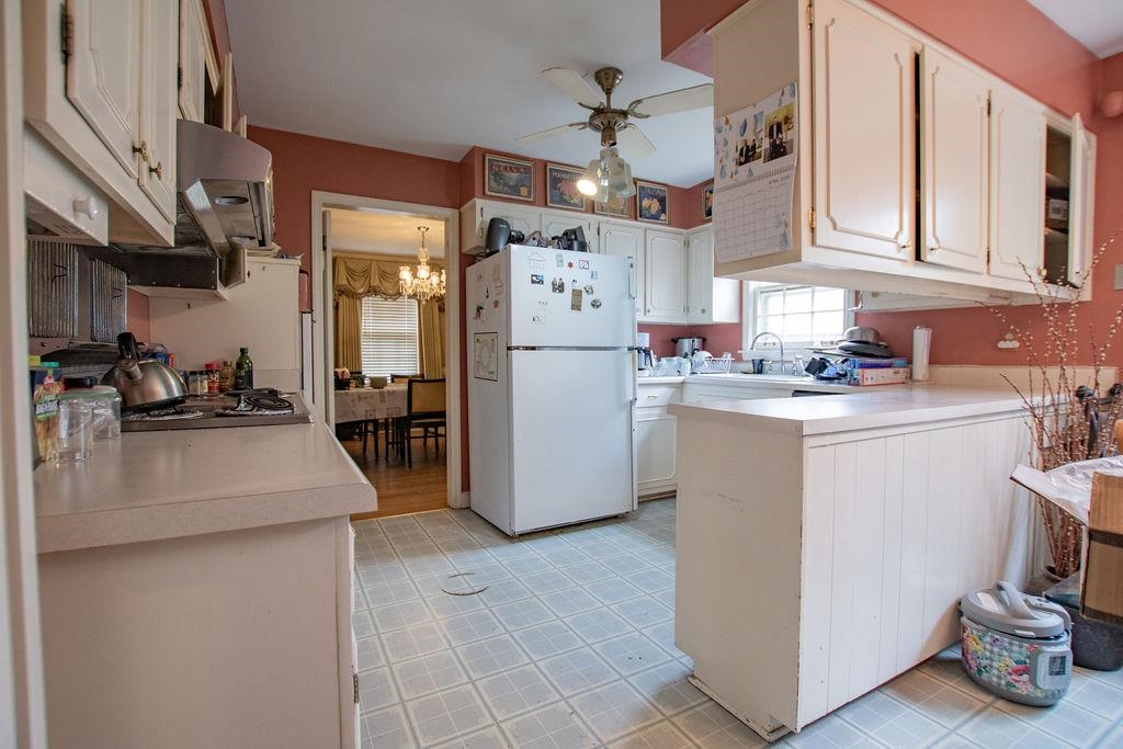 320 South Yates Road Memphis, TN 38120 - Photo 8 of 14 a kitchen with stainless steel appliances granite countertop a stove a sink dishwasher and a refrigerator with white cabinets