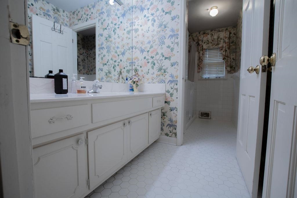 320 South Yates Road Memphis, TN 38120 - Photo 10 of 14 a bathroom with a sink and a mirror