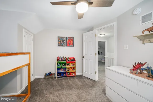 a bedroom with furniture and a flat screen tv