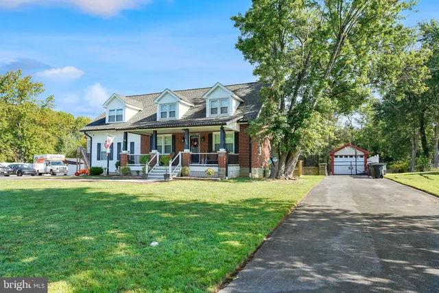 a front view of a house with swimming pool having outdoor seating