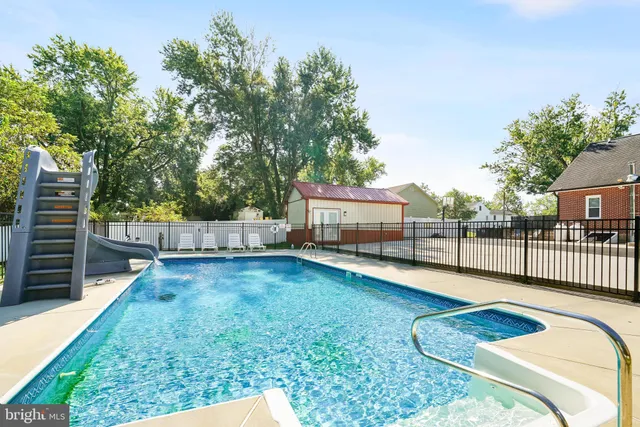 a large white kitchen with white cabinets and stainless steel appliances