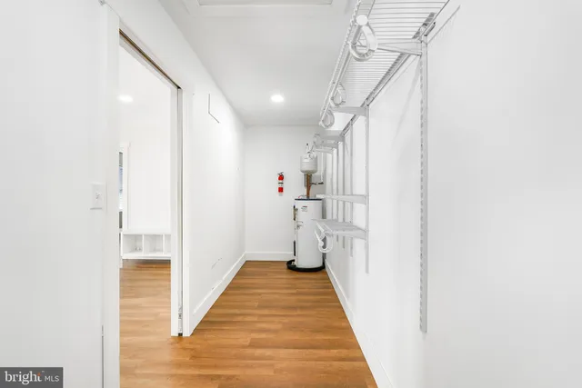 a view of open kitchen with a sink a microwave and cabinets