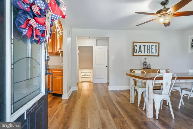 a view of a workspace with furniture and wooden floor