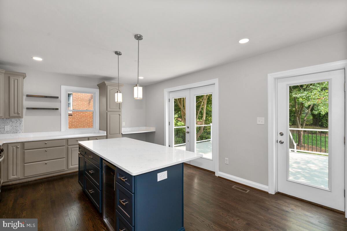 1506 Noyes Drive Silver Spring, MD 20910 - Photo 11 of 51 a kitchen with a stove a sink and wooden floor