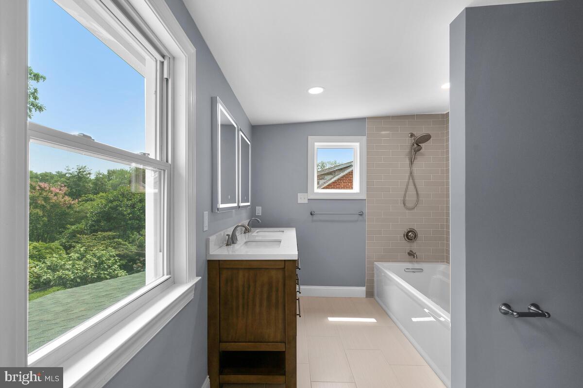 1506 Noyes Drive Silver Spring, MD 20910 - Photo 16 of 51 a bathroom with a bathtub sink and mirror