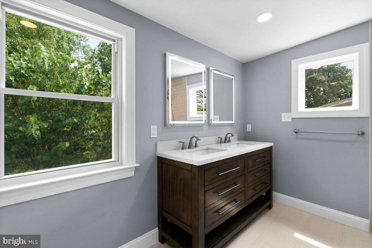 1506 Noyes Drive Silver Spring, MD 20910 - Photo 17 of 51 a bathroom with a sink window and a mirror