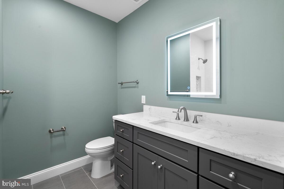 1506 Noyes Drive Silver Spring, MD 20910 - Photo 23 of 51 a bathroom with a toilet a sink and mirror