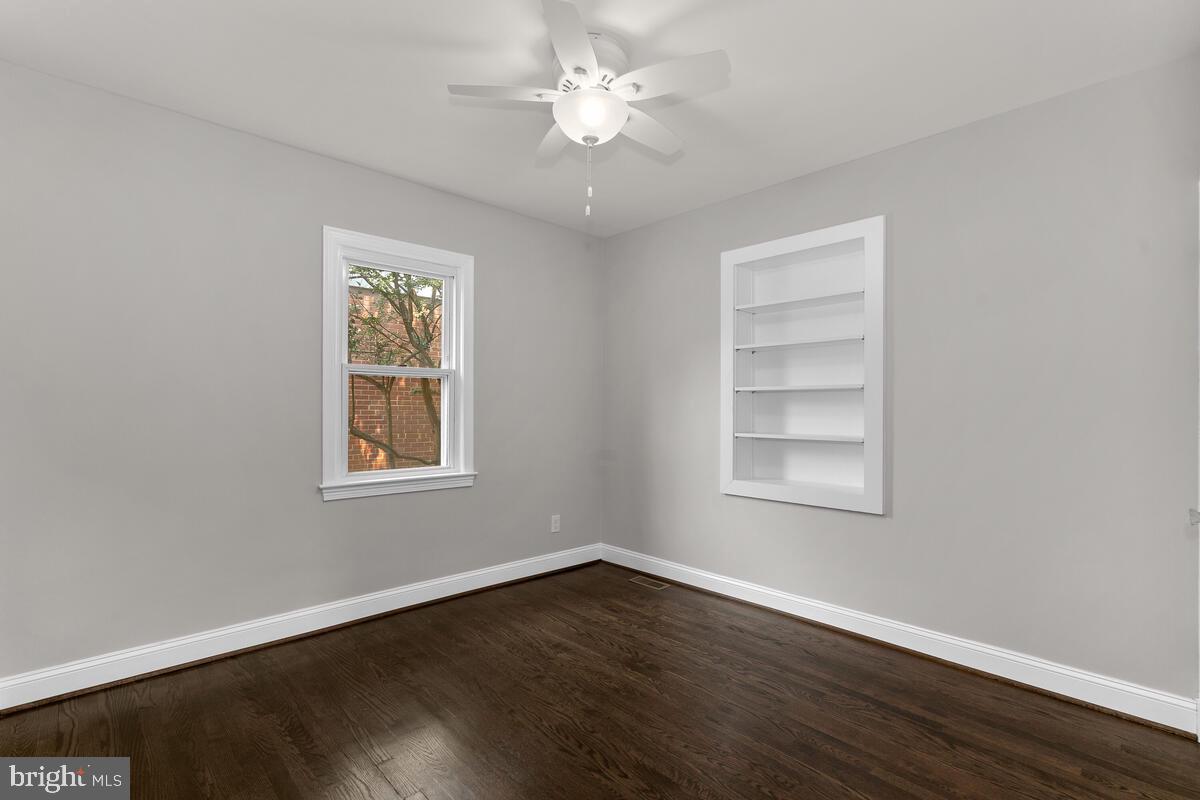1506 Noyes Drive Silver Spring, MD 20910 - Photo 25 of 51 a view of an empty room with a window and wooden floor