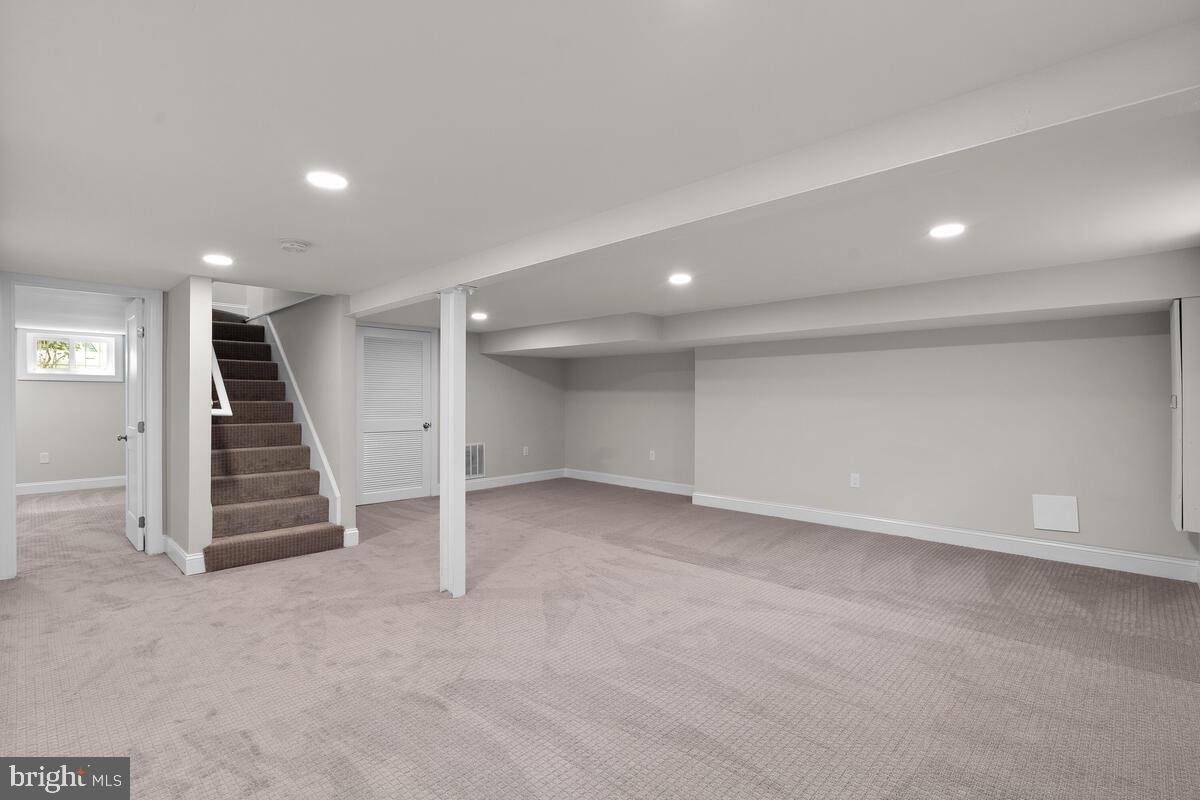 1506 Noyes Drive Silver Spring, MD 20910 - Photo 32 of 51 an empty room with wooden floor and stairs