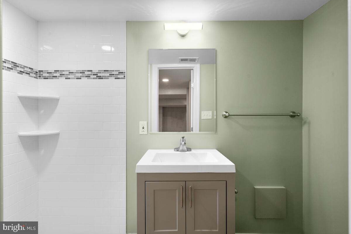1506 Noyes Drive Silver Spring, MD 20910 - Photo 34 of 51 a bathroom with a sink a mirror and shower