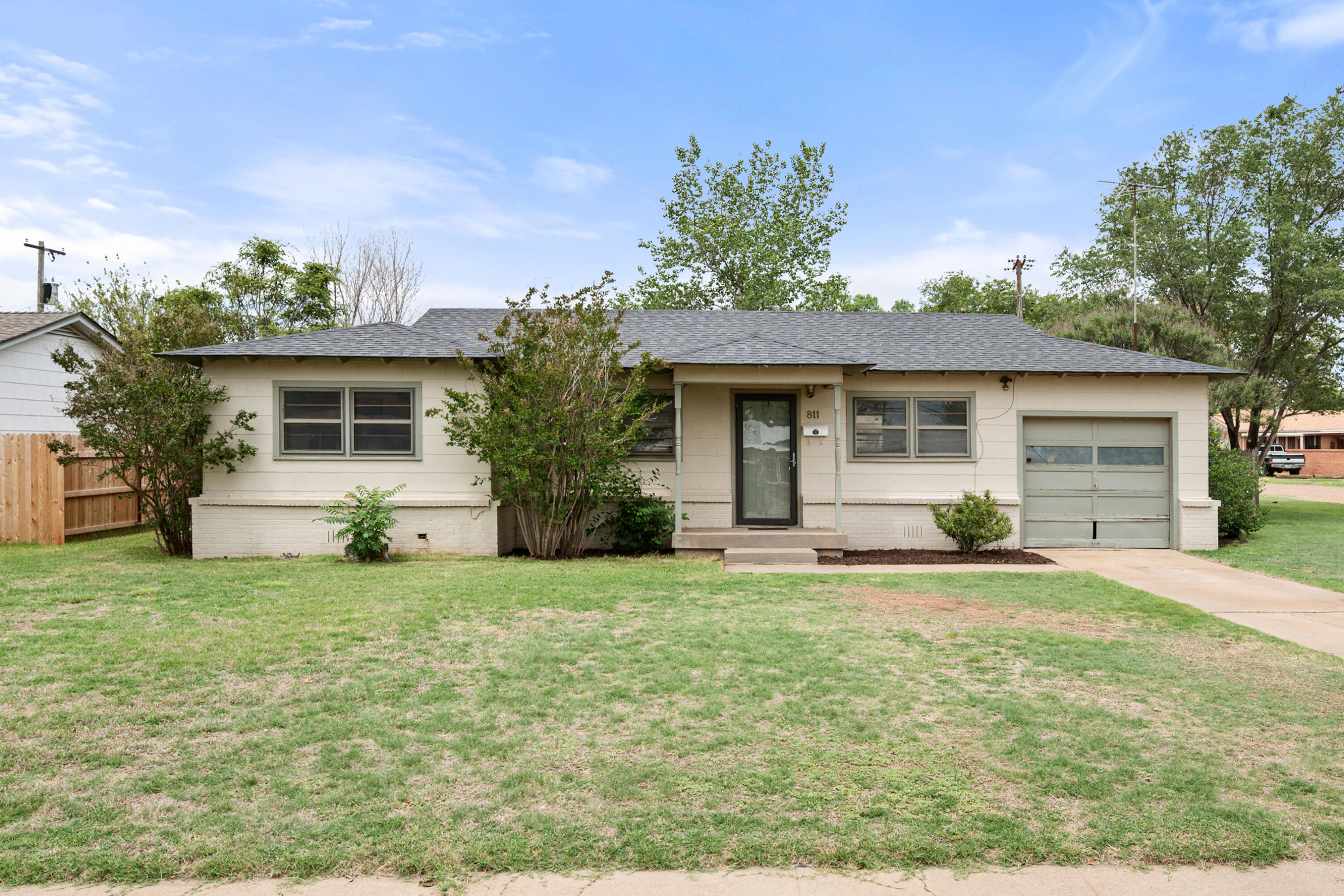 811 Zephyr Plainview, TX 79072 - Photo 1 of 25 a front view of a house with a garden and yard