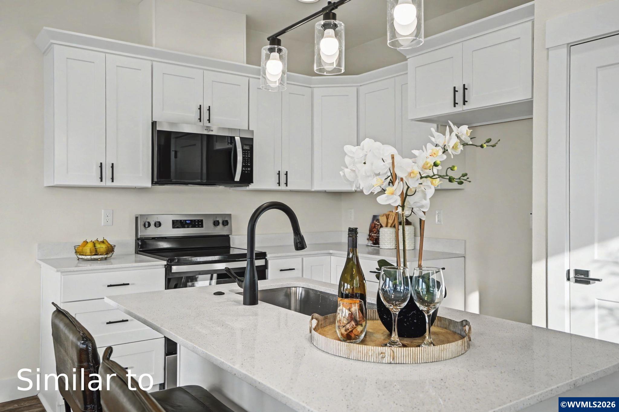 2550 Promise Way Lebanon, OR 97355 - Photo 12 of 35 a kitchen with a sink a microwave and cabinets