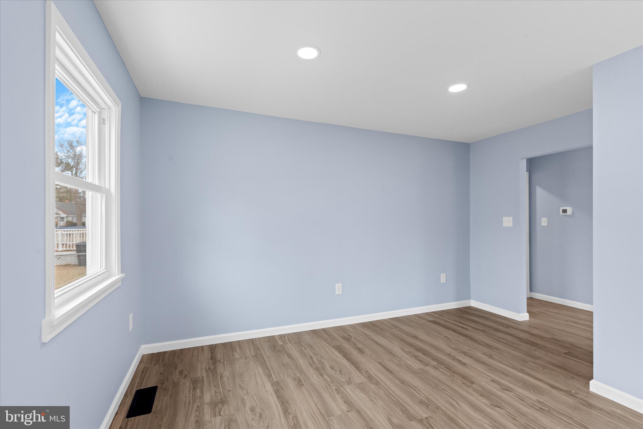 908 Spring Avenue Salisbury, MD 21804 - Photo 13 of 39 a view of an empty room with wooden floor and a window