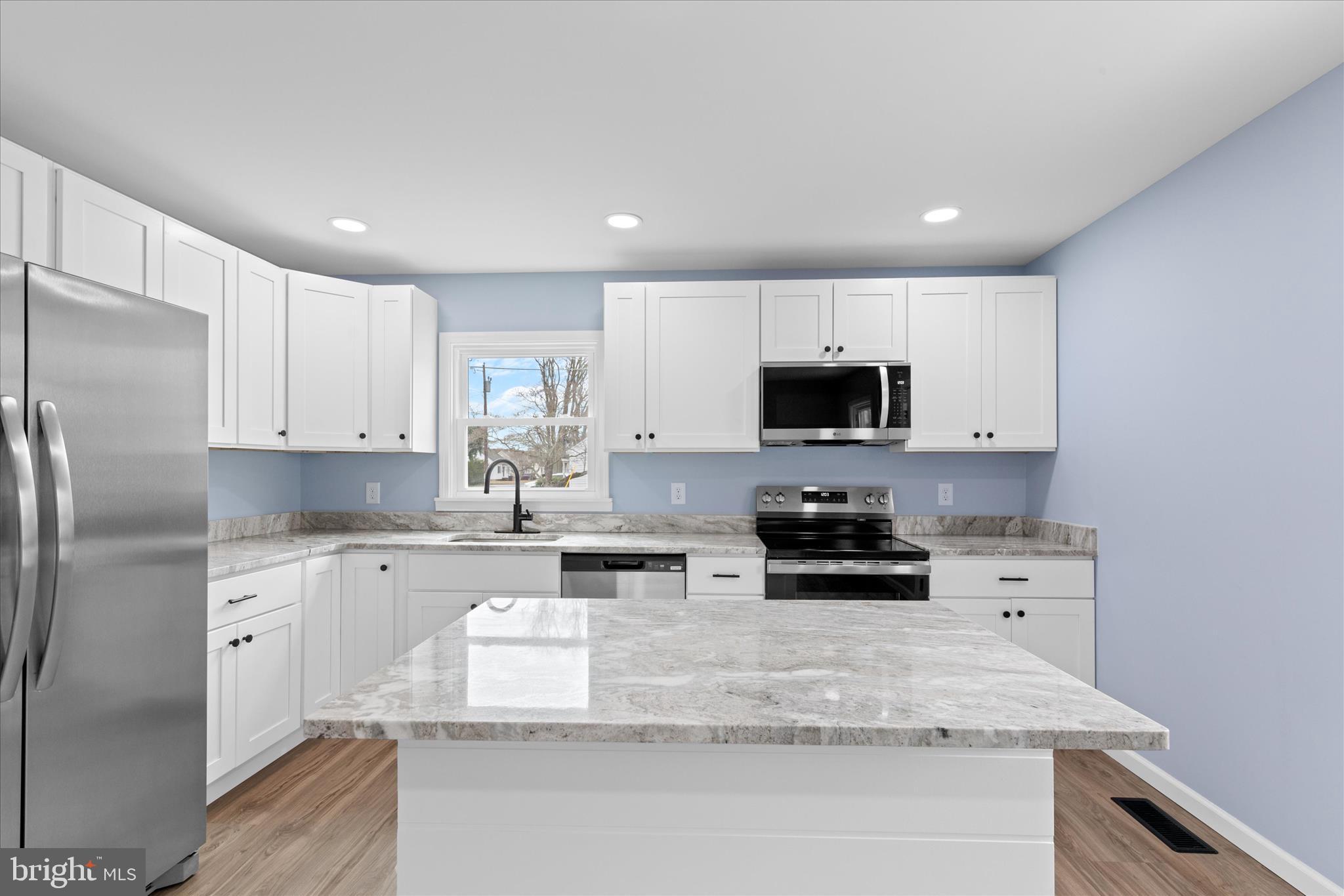 908 Spring Avenue Salisbury, MD 21804 - Photo 16 of 39 a kitchen with stainless steel appliances granite countertop a stove a sink and a refrigerator
