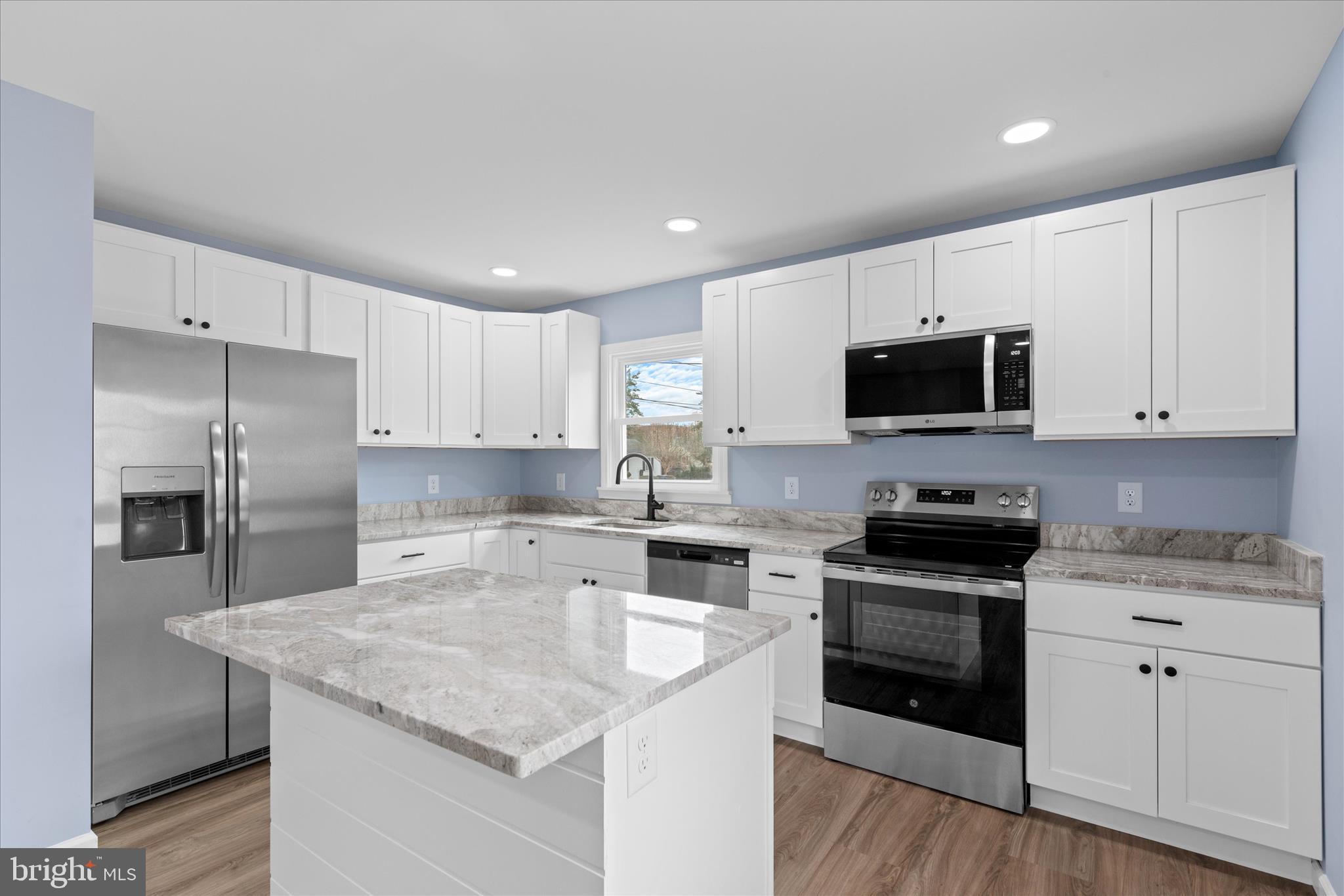 908 Spring Avenue Salisbury, MD 21804 - Photo 17 of 39 a kitchen with a sink a stove a microwave and cabinets