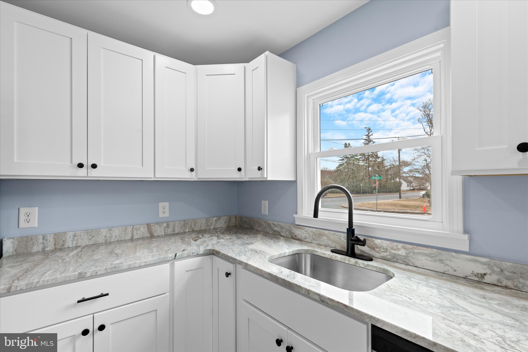 908 Spring Avenue Salisbury, MD 21804 - Photo 18 of 39 a kitchen with granite countertop white cabinets and window