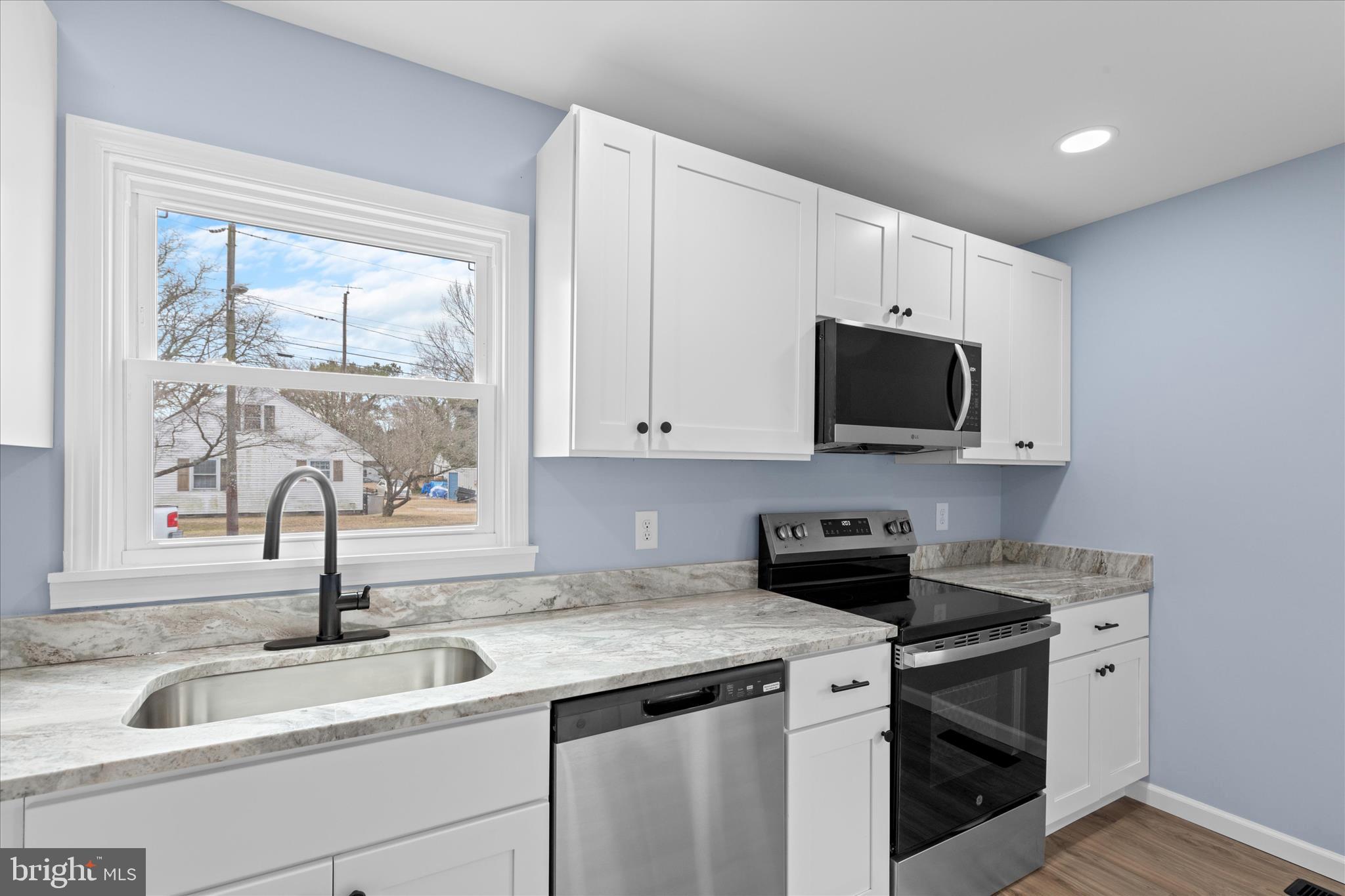 908 Spring Avenue Salisbury, MD 21804 - Photo 19 of 39 a kitchen with granite countertop a sink and a window