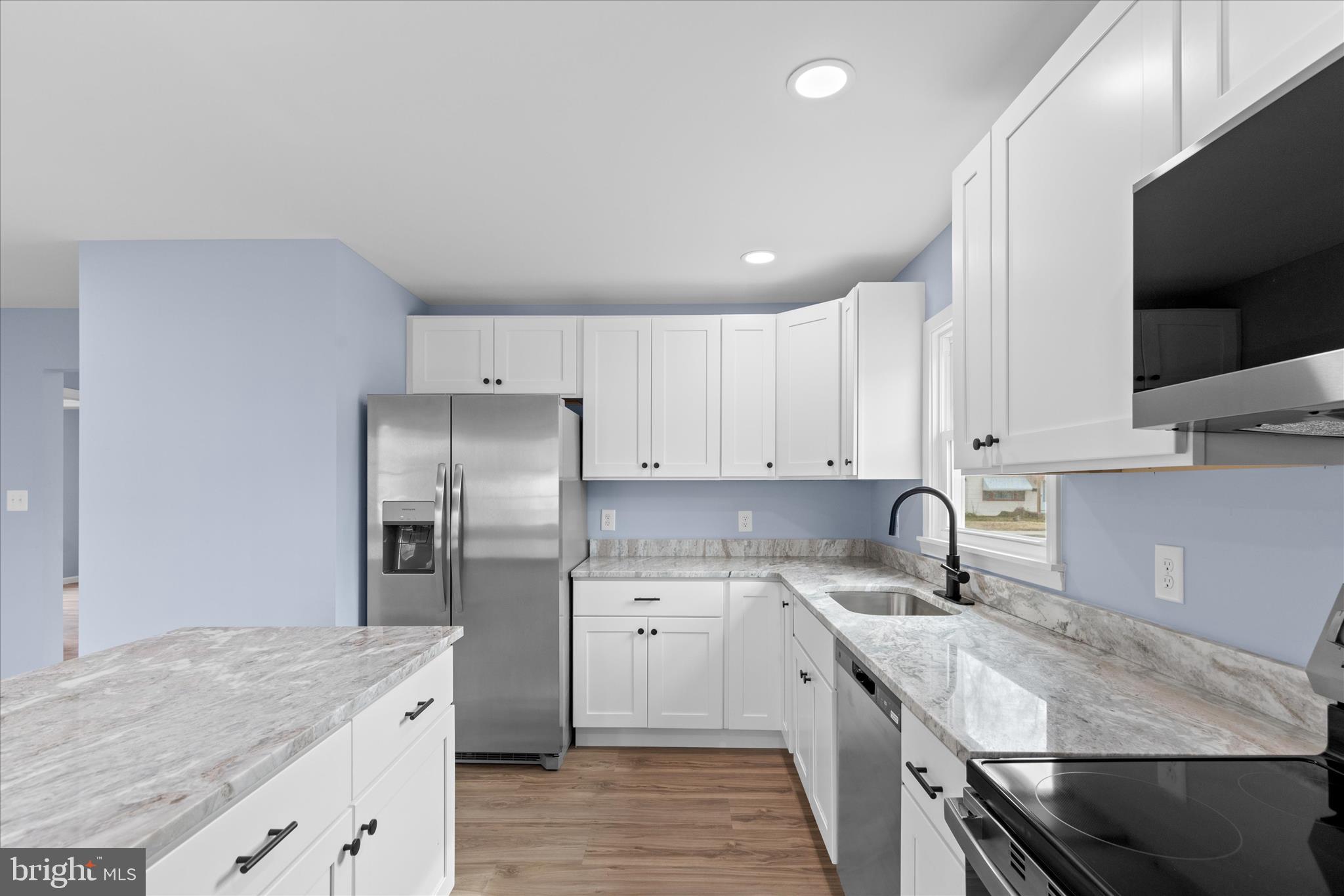 908 Spring Avenue Salisbury, MD 21804 - Photo 20 of 39 a kitchen with stainless steel appliances granite countertop a sink stove and refrigerator