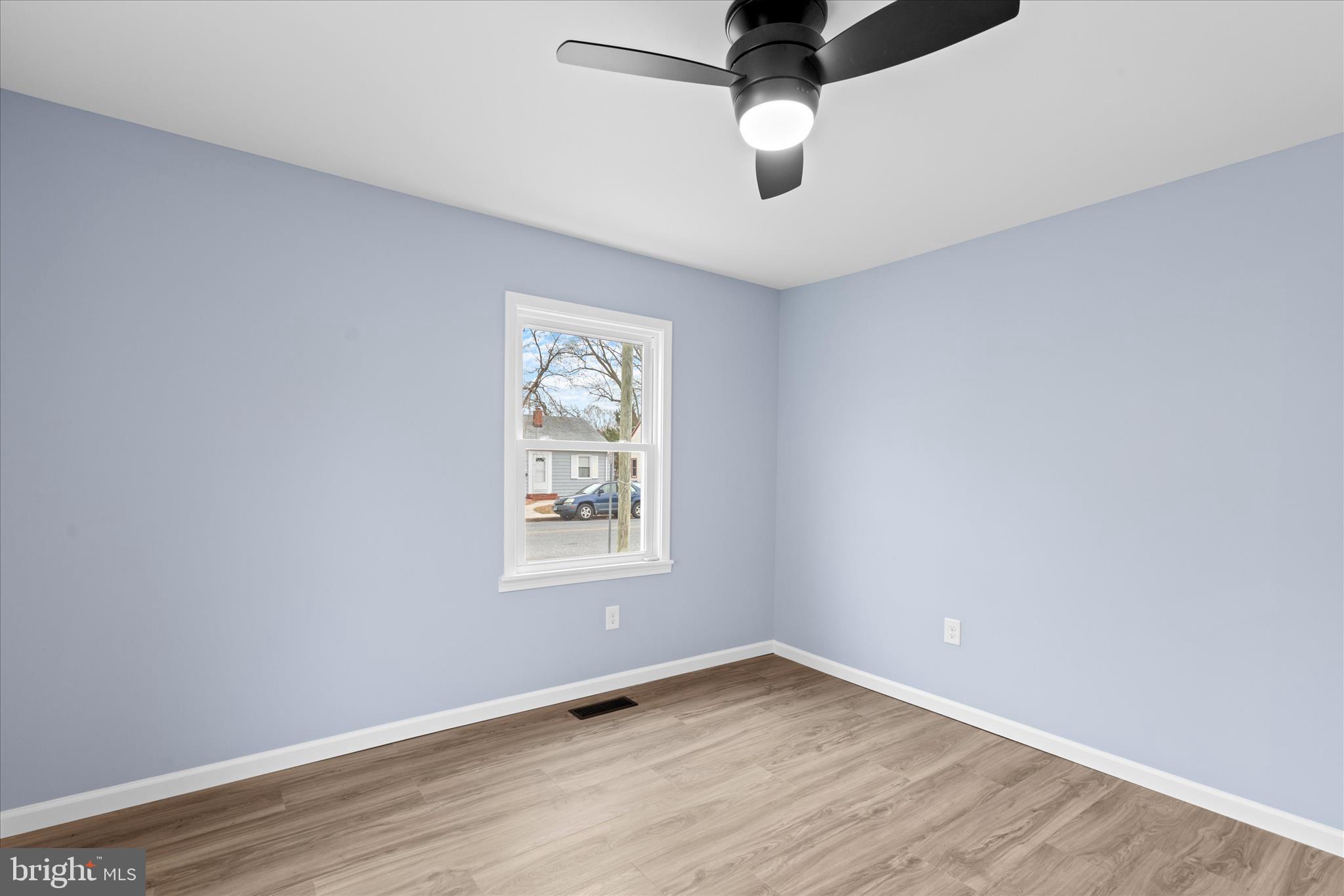 908 Spring Avenue Salisbury, MD 21804 - Photo 27 of 39 an empty room with wooden floor and windows