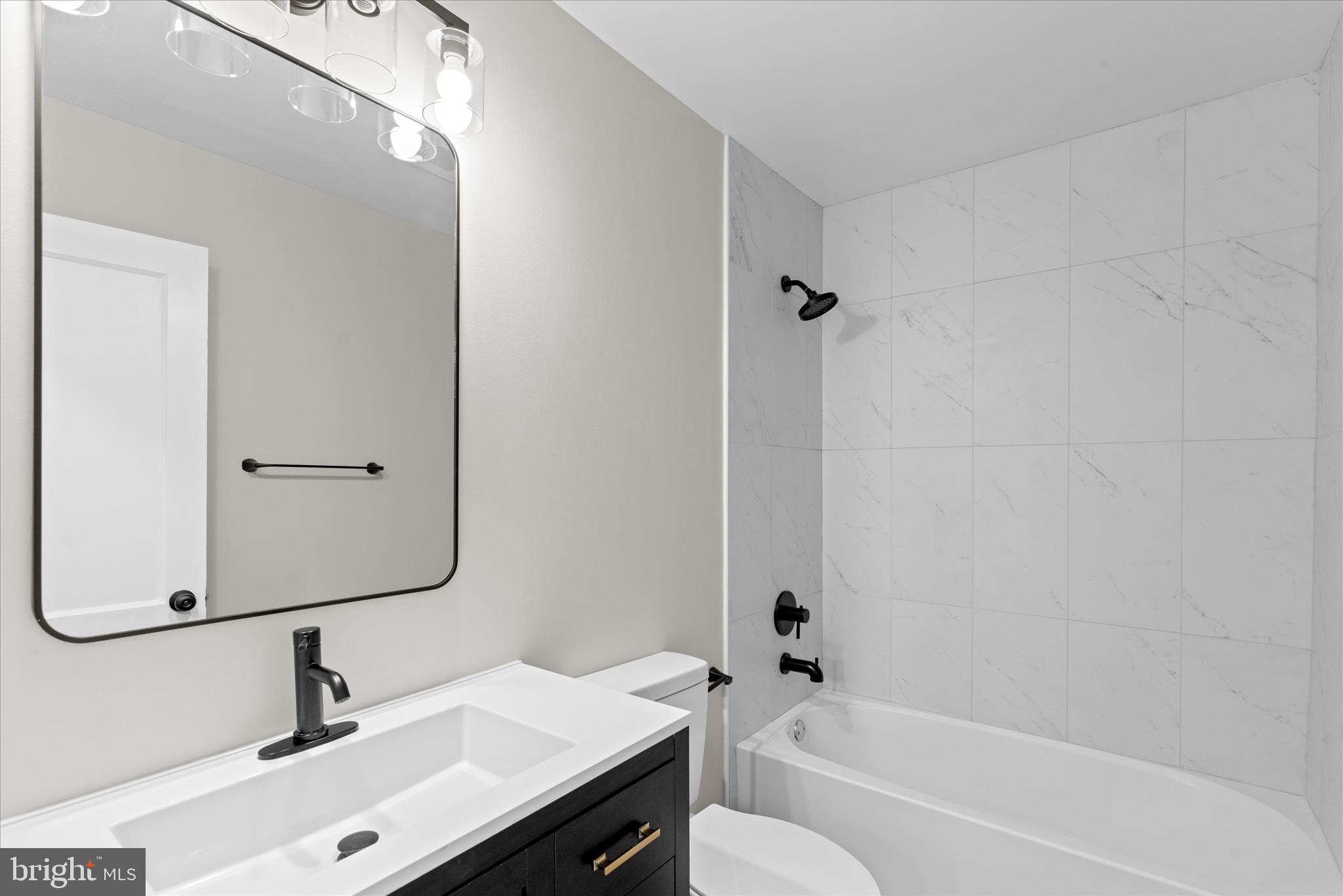 908 Spring Avenue Salisbury, MD 21804 - Photo 29 of 39 a bathroom with a sink a toilet and shower