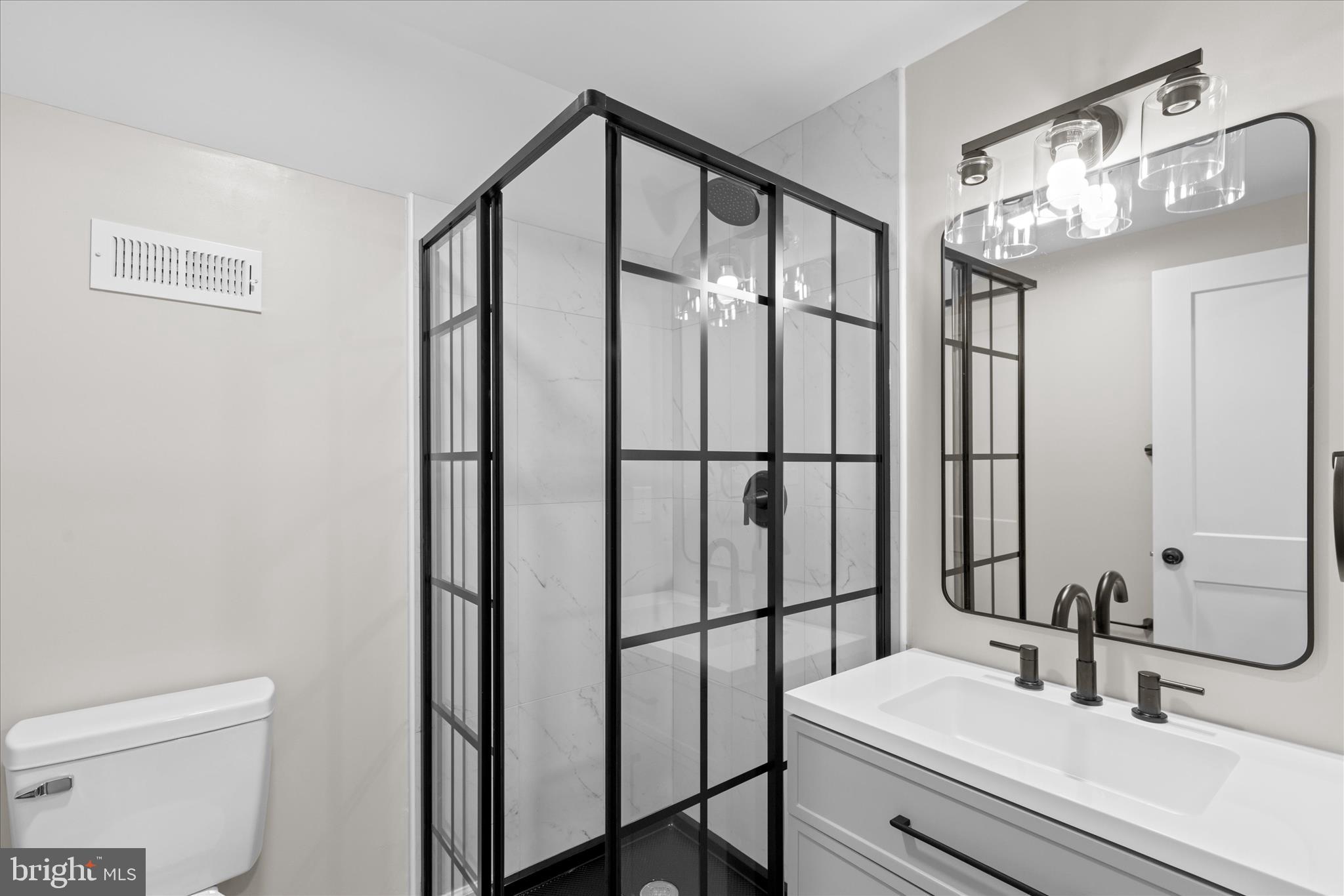 908 Spring Avenue Salisbury, MD 21804 - Photo 37 of 39 a bathroom with a sink a toilet and mirror