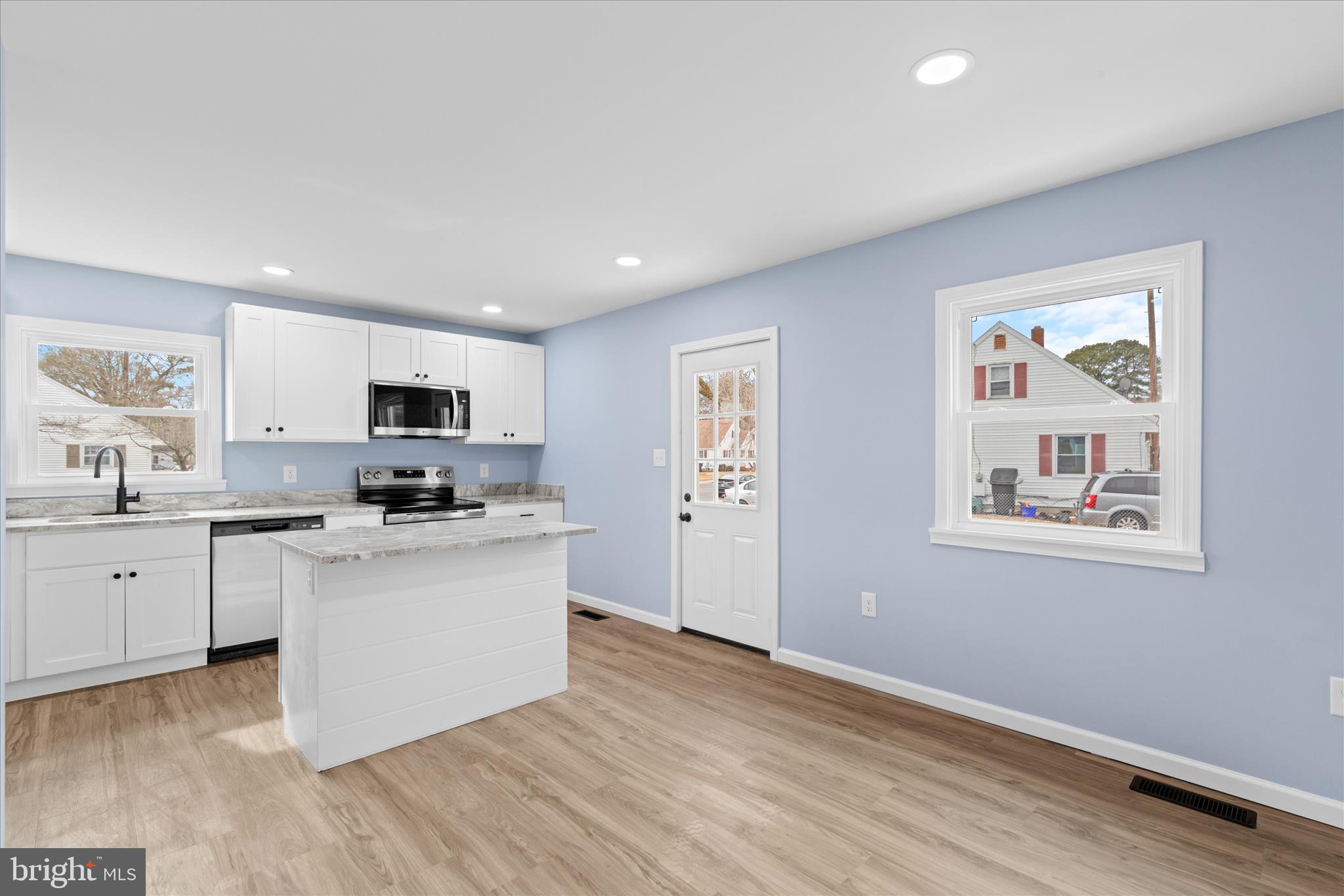 908 Spring Avenue Salisbury, MD 21804 - Photo 10 of 39 a kitchen with stainless steel appliances a white stove top oven sink and cabinets