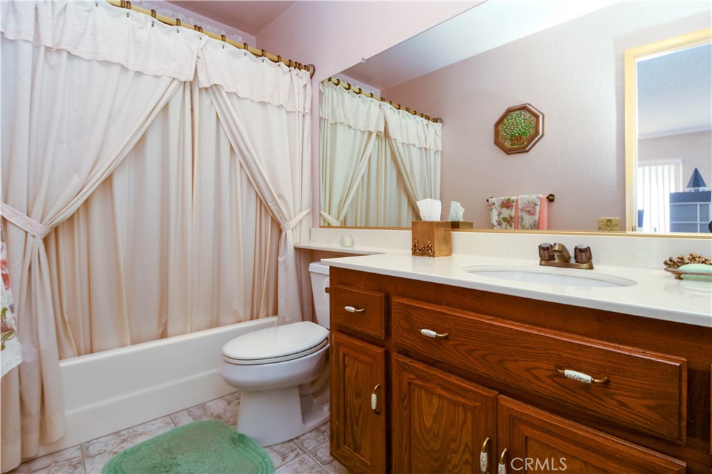 871 Kevin Corona, CA 92878 - Photo 14 of 34 a bathroom with a sink a toilet and a mirror