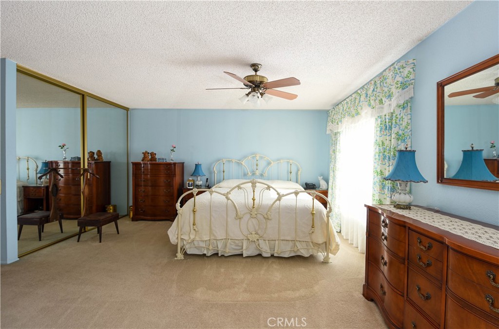 871 Kevin Corona, CA 92878 - Photo 15 of 34 a bedroom with a bed and a chandelier