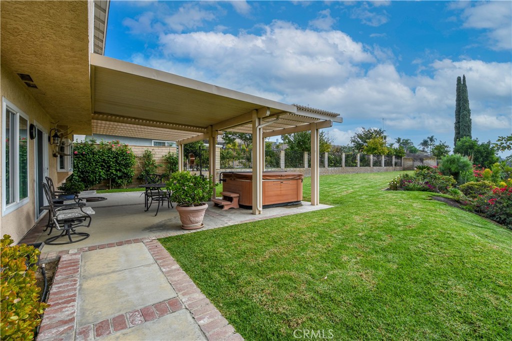 871 Kevin Corona, CA 92878 - Photo 25 of 34 a view of a patio with table and chairs potted plants and floor to ceiling window