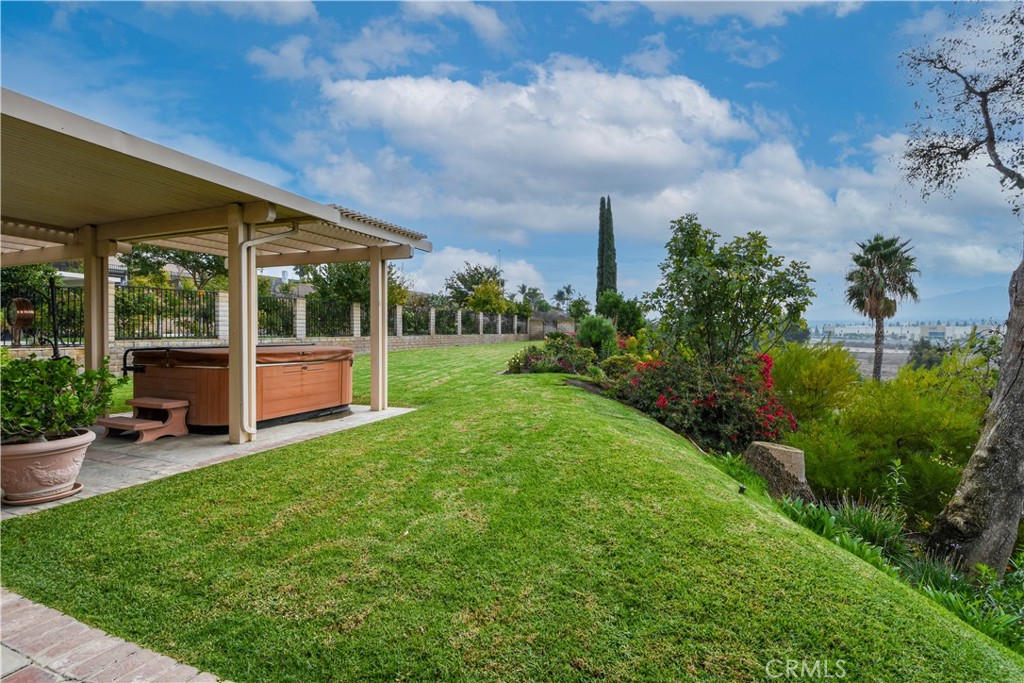 871 Kevin Corona, CA 92878 - Photo 26 of 34 a view of a patio with table and chairs potted plants and floor to ceiling window