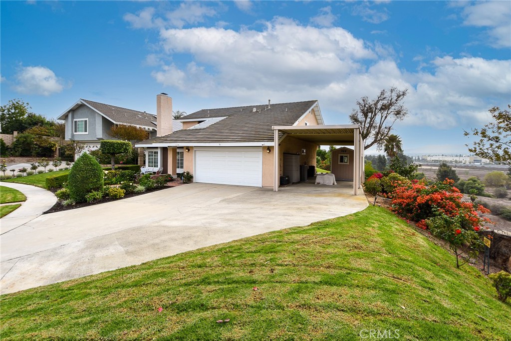871 Kevin Corona, CA 92878 - Photo 34 of 34 a front view of a house with a garden and yard