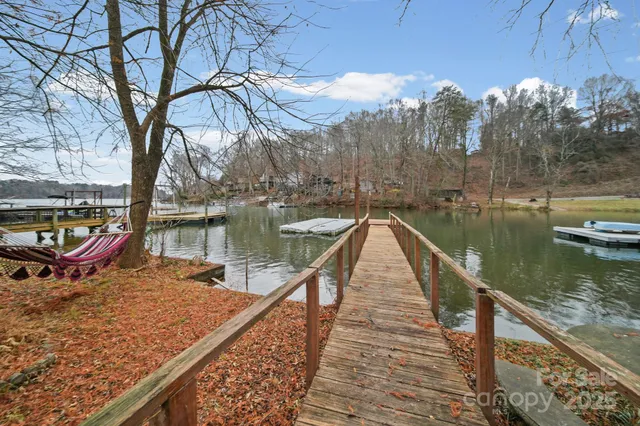 a wooden bench sitting next to a lake