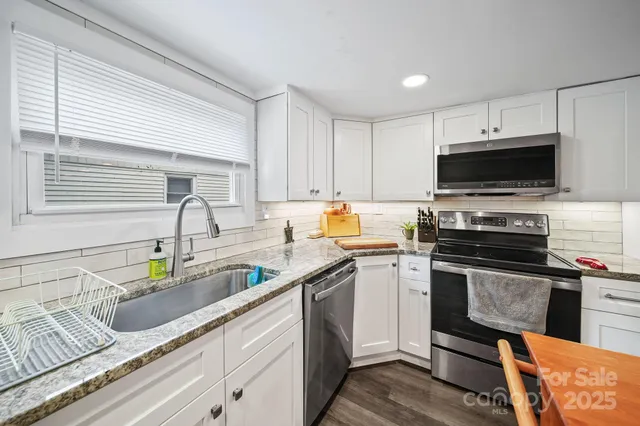 a kitchen with a refrigerator and a stove top oven