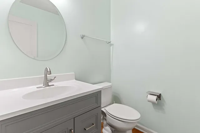 a bathroom with a sink a mirror and a toilet