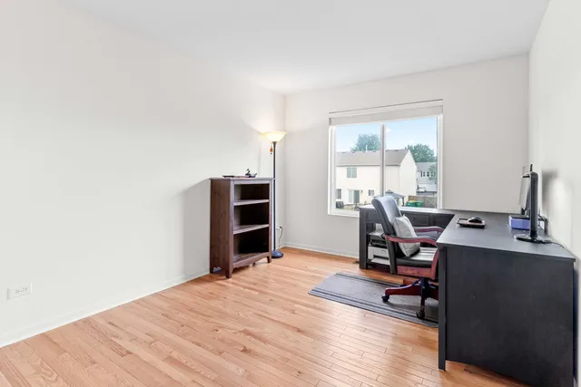a view of a workspace with furniture and a window
