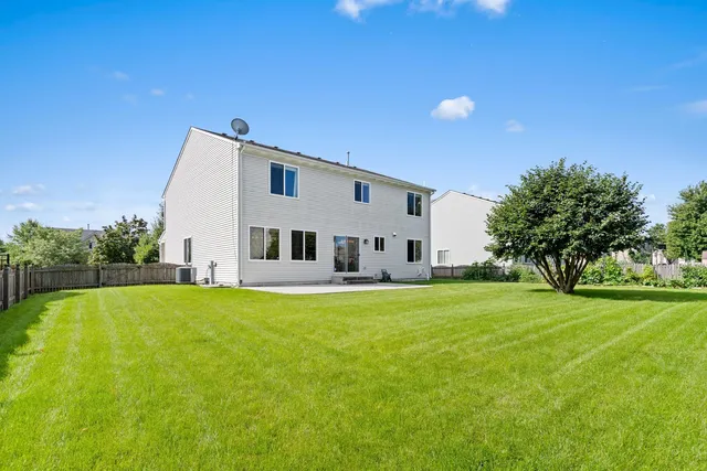 a view of a house with a backyard