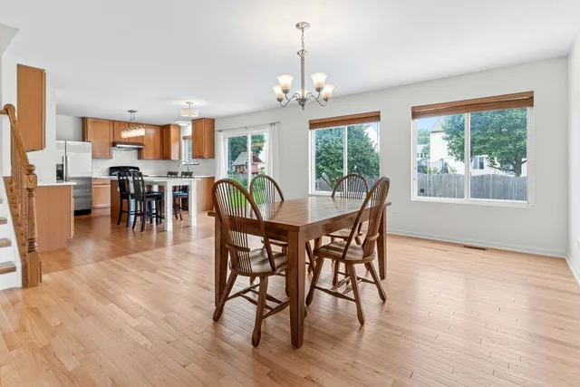 a view of a dining room with furniture window and wooden floor
