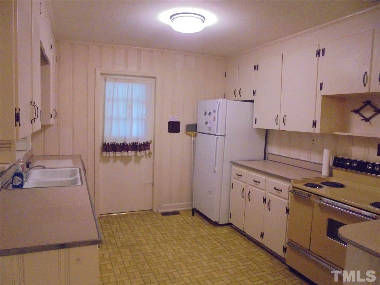 3520 Baugh Street Raleigh, NC 27604 - Photo 14 of 17 a kitchen with white cabinets and white appliances