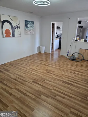 a view of a room with wooden floor
