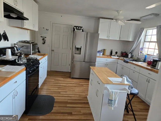 a kitchen with a sink a stove and refrigerator