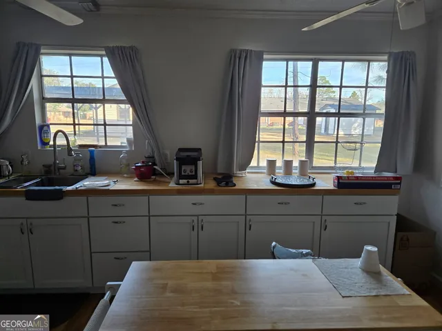 a kitchen with a sink window and cabinets
