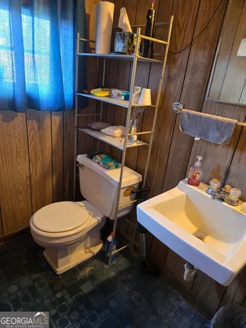 a bathroom with a toilet a sink and a shower