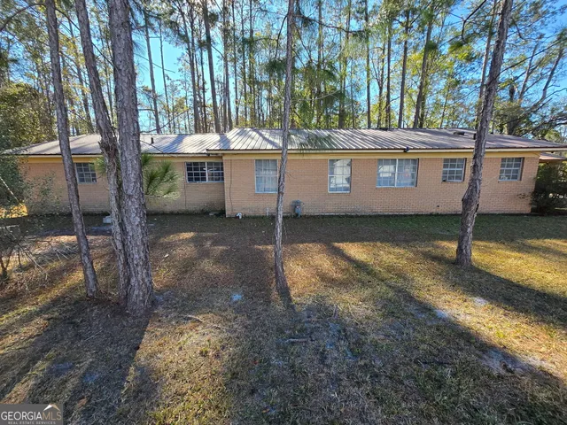 a view of a house with backyard and tree