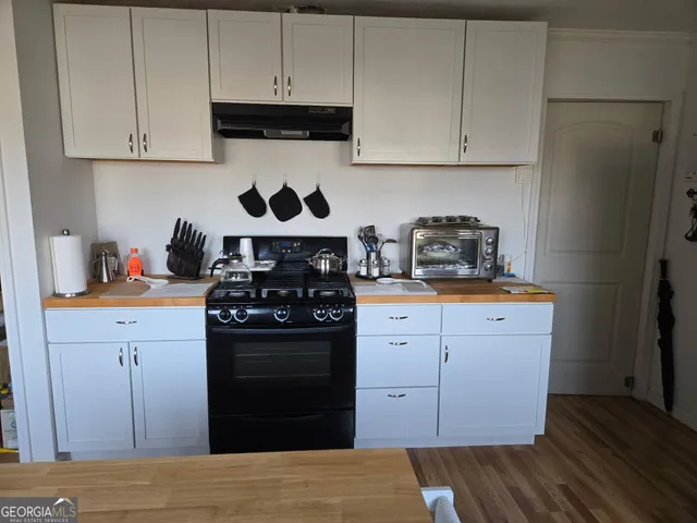 a kitchen with stainless steel appliances granite countertop a stove and a refrigerator with cabinets
