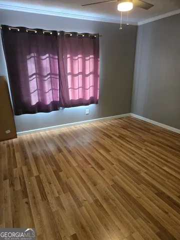 a view of wooden floor and windows in a room