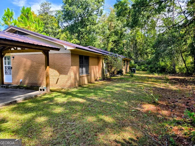 a backyard of a house with barbeque oven