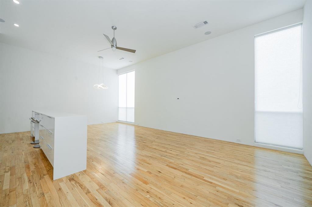 2325 Rusk Place Dallas, TX 75204 - Photo 12 of 27 a view of empty room with wooden floor and fan