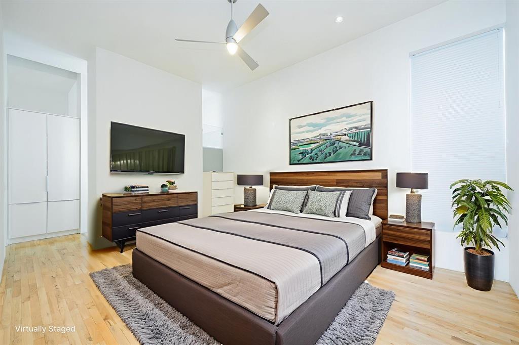 2325 Rusk Place Dallas, TX 75204 - Photo 17 of 27 a bedroom with a bed and a flat screen tv